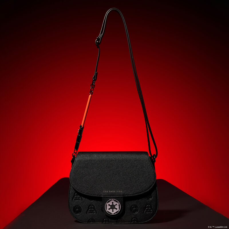 Loungefly Star Wars Dark Side Light Saber Strap Crossbody Bag featuring the Empire's symbol on the front of the bag and a red light saber attached to the crossbody strap sitting against a dark red background.